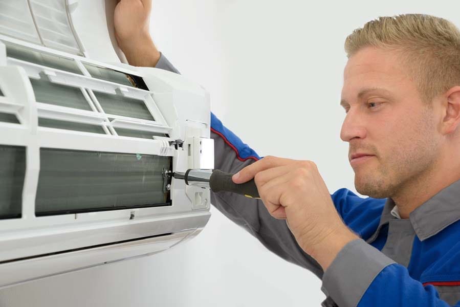 Portrait Of Young Male Technician Repairing Air Conditioner in Pittsburg