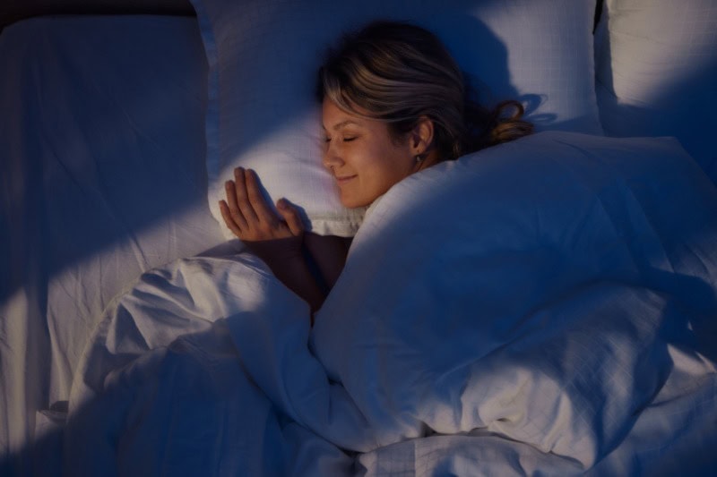 Your HVAC System Can Enhance Sleep. Woman sleeping soundly in her comfy bed.