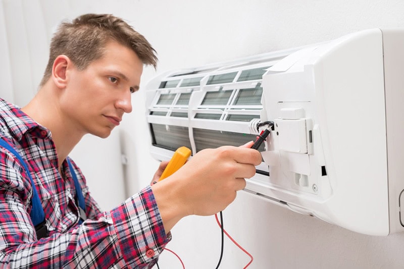 man repairing air conditioner