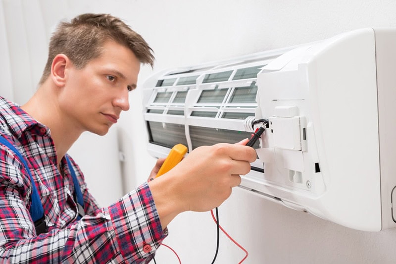 man repairing air conditioner, What You Need to Know for an HVAC Emergency