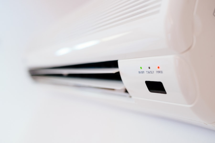 White home air conditioner mounted on apartment wall.