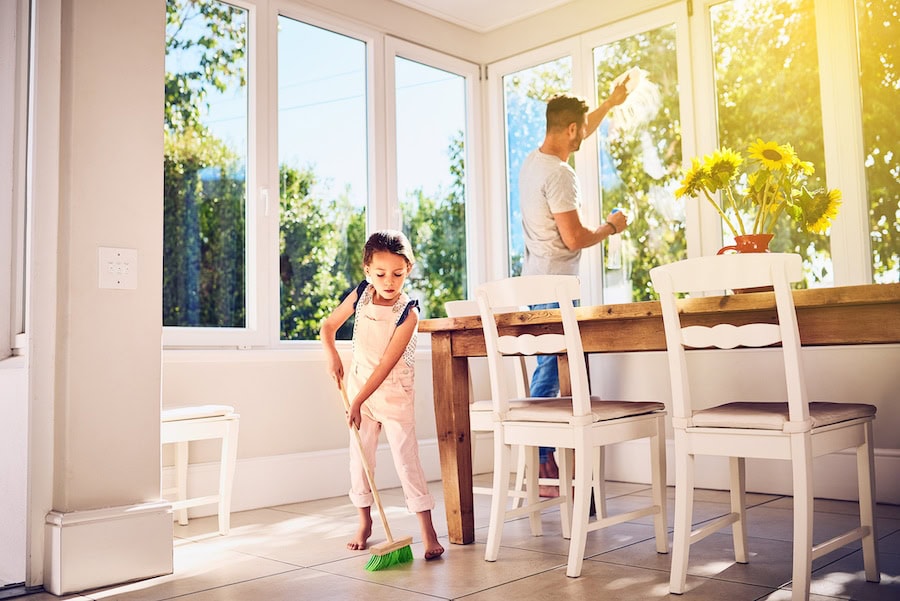 Shot of a father and his little daughter doing chores together at home.